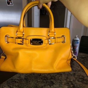 Michael Kors Handbag. Yellow/ Squash color. Used fair condition.